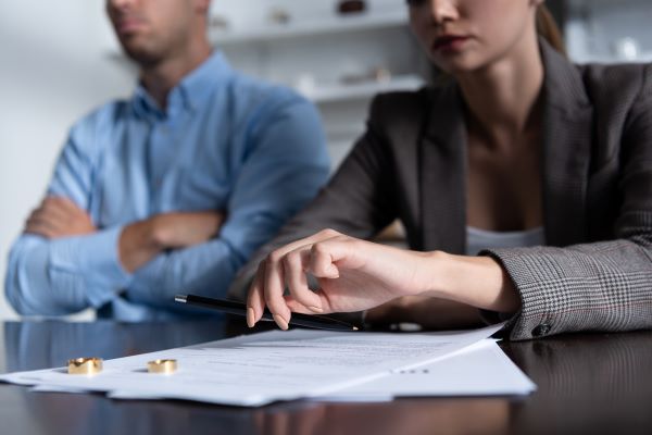 man and woman with papers and rings on table