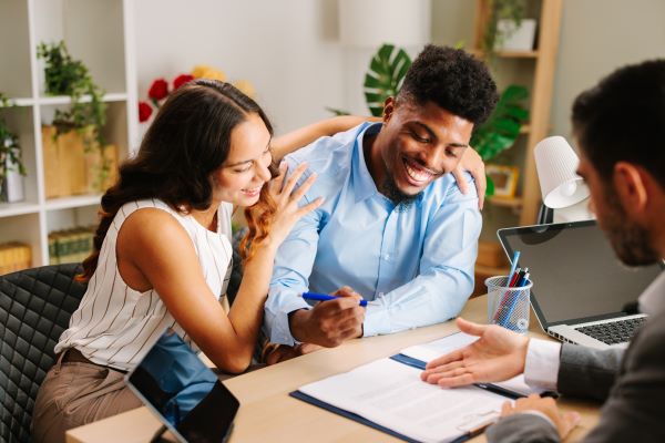 young Latin American couple signing a document